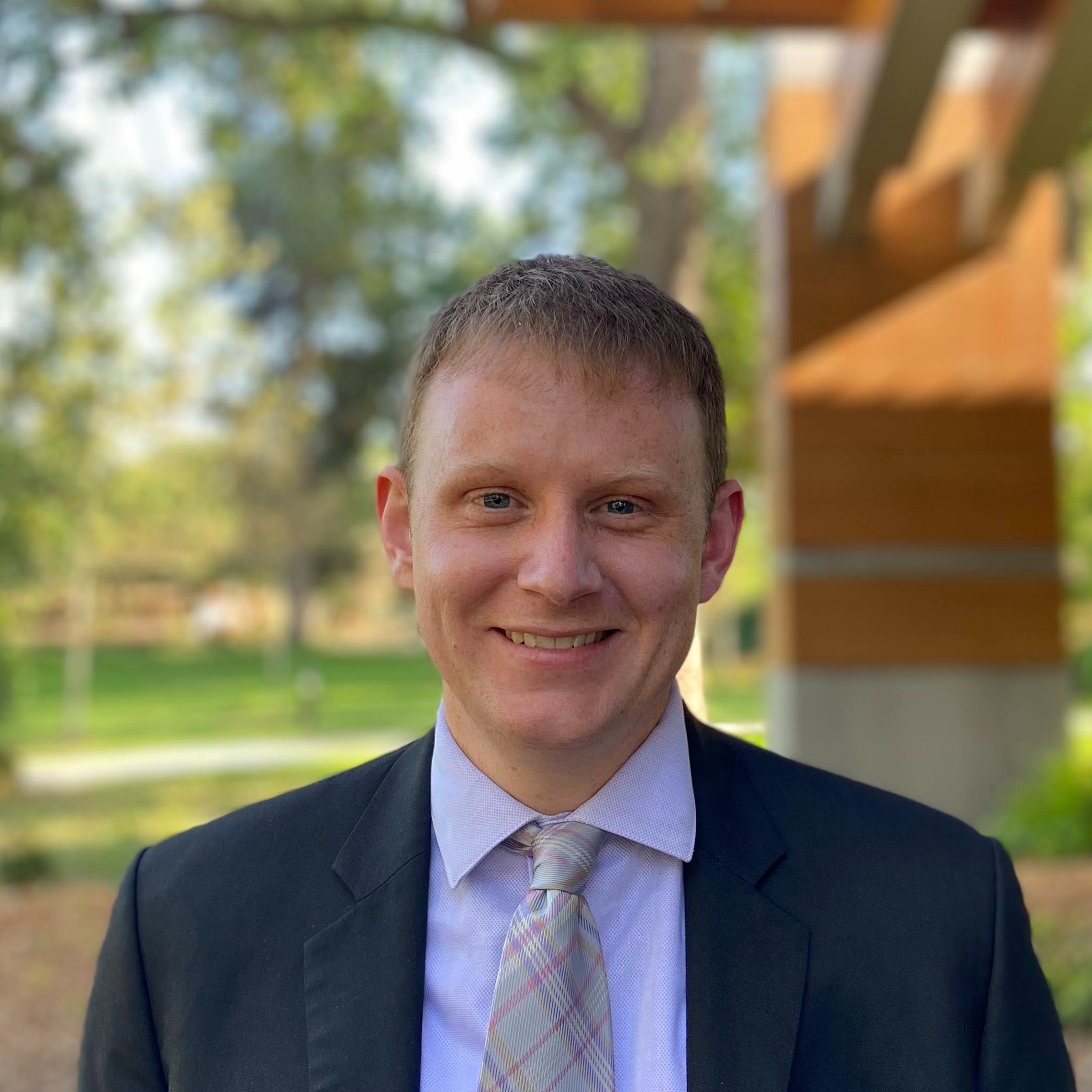 Photo of Alexander Bentz in suit, smiling